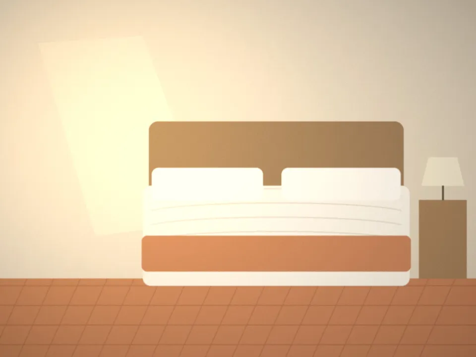 Seconde chambre du gîte avec tomettes et plaid terracotta