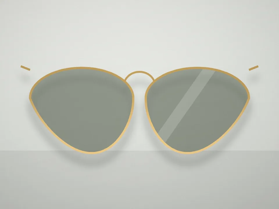 Monture aviateur métal doré, verres teintés posée sur un présentoir clair (modèle d'exemple)
