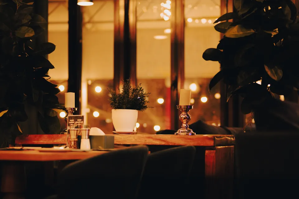 La salle le soir, tables dressées et lumière chaude
