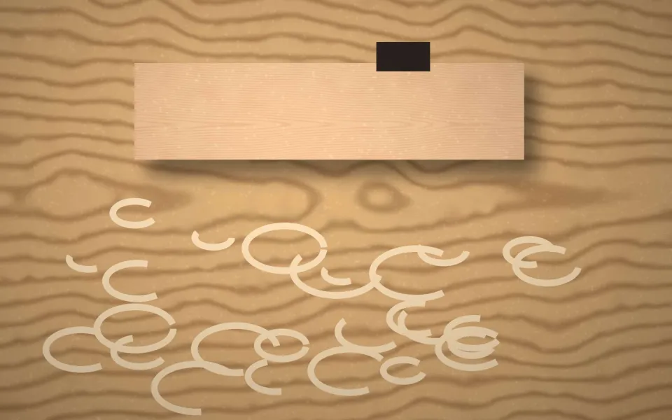 Rabot posé sur une planche avec des copeaux