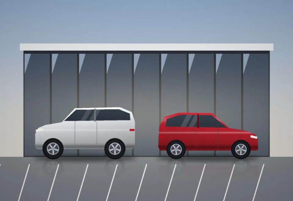 La façade vitrée de la concession et son parking d'exposition